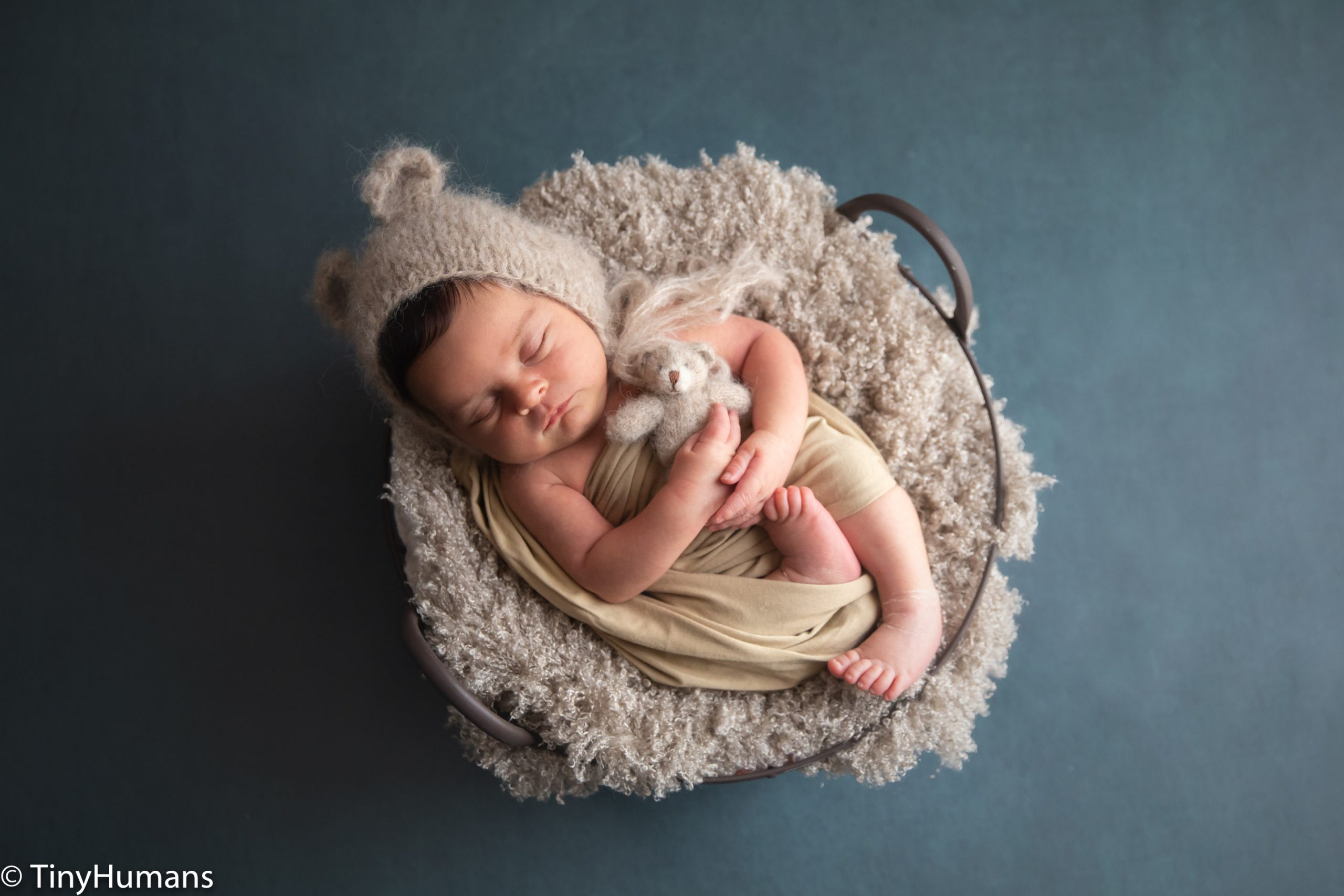 Sleeping newborn with teddy bear