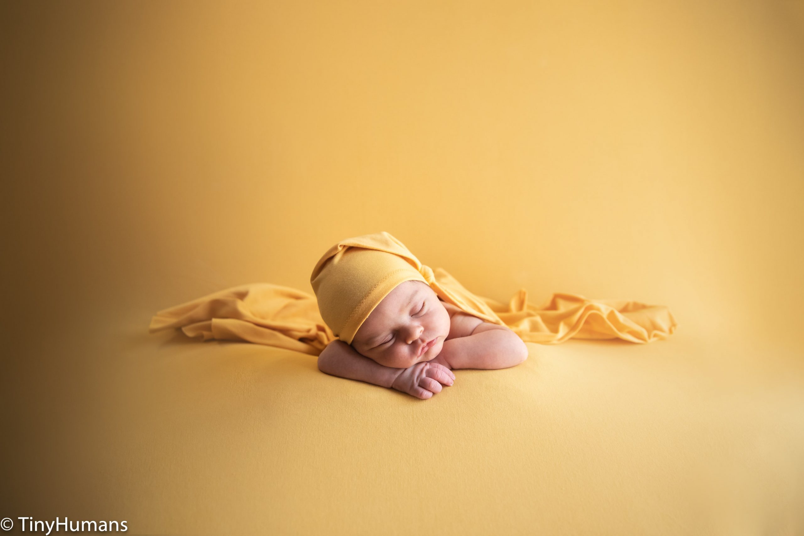 Newborn on yellow background