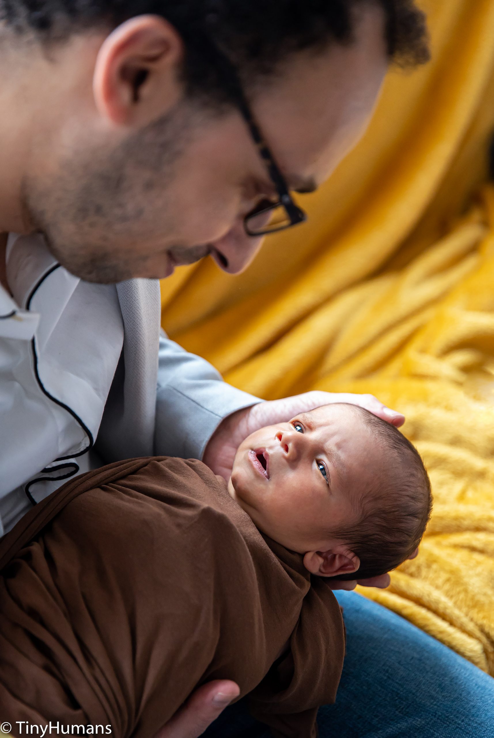 Daddy cuddles newborn